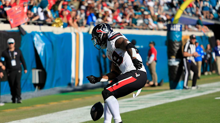 Houston Texans running back Joe Mixon (28) spins the ball before dancing in the endzone celebrating his touchdown score during the third quarter of an NFL football matchup Sunday, Dec. 1, 2024 at EverBank Stadium in Jacksonville, Fla. The Texans held off the Jaguars 23-20. [Corey Perrine/Florida Times-Union]