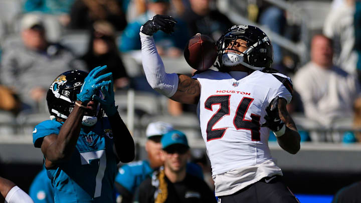 Houston Texans cornerback Derek Stingley Jr. (24) breaks up a pass intended for Jacksonville Jaguars wide receiver Brian Thomas Jr. (7) during the first quarter of an NFL football matchup Sunday, Dec. 1, 2024 at EverBank Stadium in Jacksonville, Fla. [Corey Perrine/Florida Times-Union]