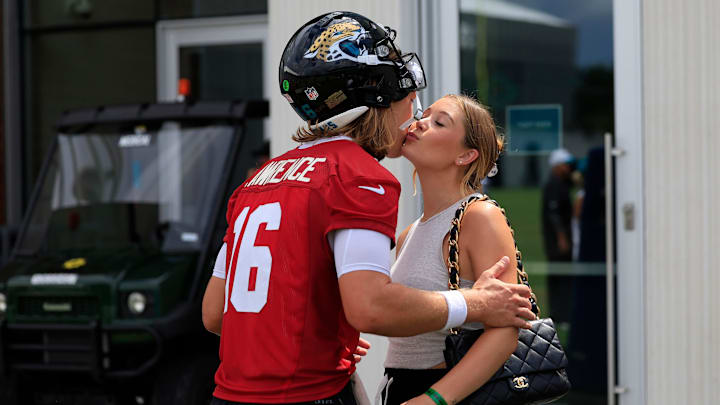 Jacksonville Jaguars quarterback Trevor Lawrence (16) kisses his wife Marissa Lawrence after a combined NFL football training camp session between the Tampa Bay Buccaneers and Jacksonville Jaguars Thursday, Aug. 15, 2024 at EverBank Stadium’s Miller Electric Center in Jacksonville, Fla. [Corey Perrine/Florida Times-Union]
