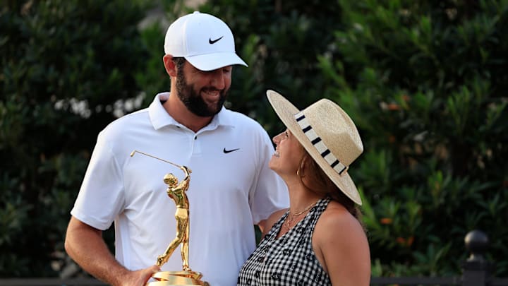 Scottie Scheffler looks to his wife Meredith Scudder as he poses for photos with the championship trophy after the fourth and final round of The Players Championship PGA golf tournament Sunday, March 17, 2024. Scottie Scheffler looks to his wife Meredith Scudder as he poses for photos with the championship trophy after the fourth and final round of The Players Championship PGA golf tournament Sunday, March 17, 2024.
