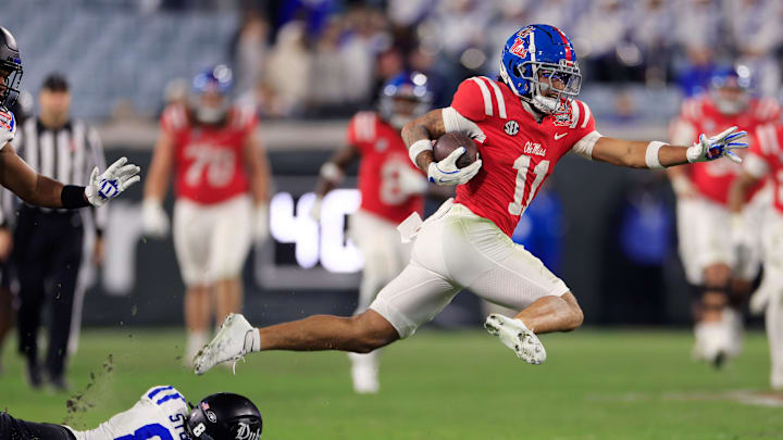 Mississippi Rebels wide receiver Jordan Watkins (11) breaks a final attempted tackle from Duke Blue Devils safety DaShawn Stone (8) en route to a touchdown during the fourth quarter of the TaxSlayer Gator Bowl Thursday, Jan. 2, 2025 at EverBank Stadium in Jacksonville, Fla. Ole Miss defeated Duke 52-20. [Corey Perrine/Florida Times-Union]