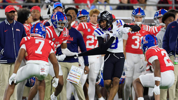 Duke Blue Devils wide receiver Jordan Moore (8) has his jersey ripped by Mississippi Rebels cornerback Chris Graves Jr. (32) as he is forced out of bounds during the third quarter of the TaxSlayer Gator Bowl Thursday, Jan. 2, 2025 at EverBank Stadium in Jacksonville, Fla. Ole Miss defeated Duke 52-20. [Corey Perrine/Florida Times-Union]