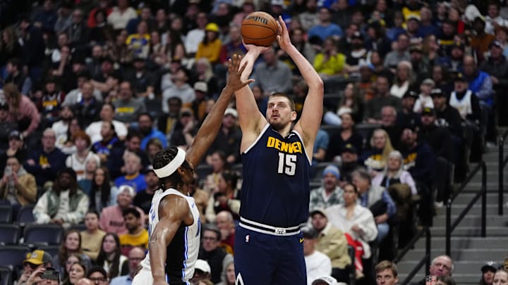 Denver Nuggets center Nikola Jokic (15) shoots against Orlando Magic forward Paolo Banchero (5) in the second quarter at Ball Arena.