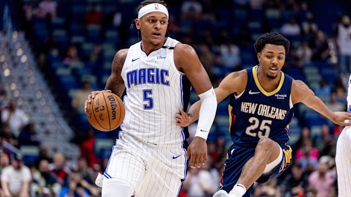 Orlando Magic forward Paolo Banchero (5) dribbles around New Orleans Pelicans guard Trey Murphy III (25) during the first half at Smoothie King Center.