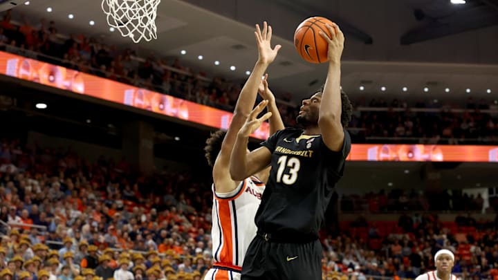 Feb 10, 2026; Auburn, Alabama, USA;  Vanderbilt Commodores forward Jalen Washington (13) takes a shot over Auburn Tigers guard Keyshawn Hall (7) during the first half at Neville Arena. Mandatory Credit: John Reed-Imagn Images