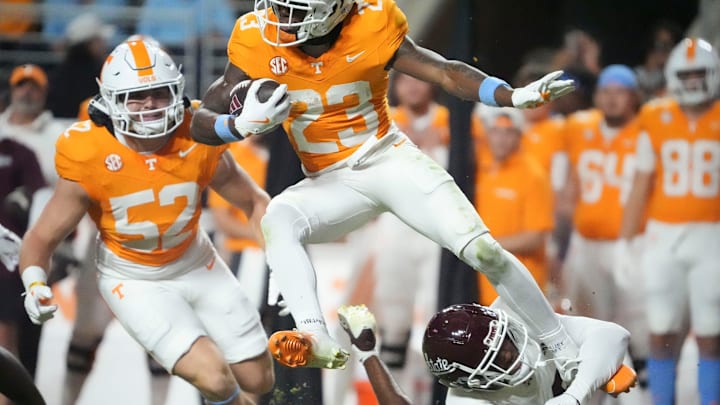 Tennessee defensive back Boo Carter (23) leaps over a Mississippi defender on a punt return during an NCAA college football game on Saturday, Nov. 9, 2024, in Knoxville, Tenn.
