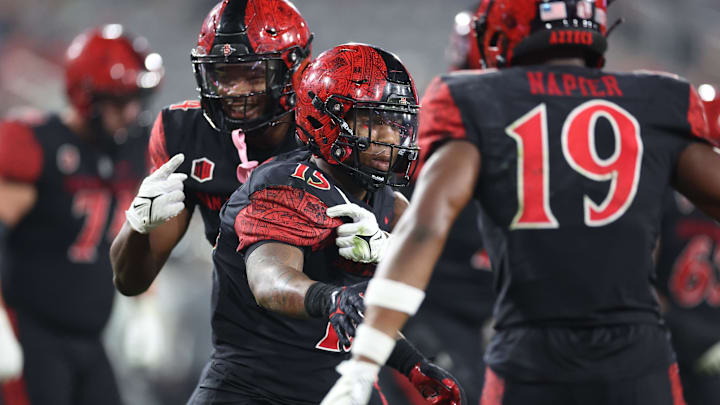 Oct 5, 2024; San Diego, California, USA; San Diego State Aztecs running back Marquez Cooper (15) celebrates after scoring a touchdown with San Diego State Aztecs wide reciever Nate Bennett (11) against the Hawaii Rainbow Warriors during the fourth quarter at Snapdragon Stadium. Mandatory Credit: Abe Arredondo-Imagn Images