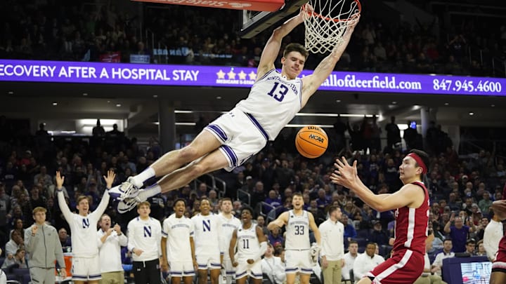 Feb 7, 2024; Evanston, Illinois, USA; Northwestern Wildcats guard Brooks Barnhizer (13) dunks the ball on Nebraska Cornhuskers guard Keisei Tominaga (30) during the second half at Welsh-Ryan Arena. Mandatory Credit: David Banks-Imagn Images