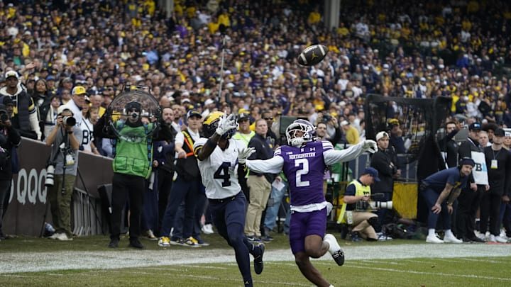 Nov 15, 2025; Chicago, Illinois, USA; Michigan Wolverines wide receiver Andrew Marsh (4) makes a catch as Northwestern Wildcats cornerback Fred Davis II (2) defends him during the first half at Wrigley Field. Mandatory Credit: David Banks-Imagn Images