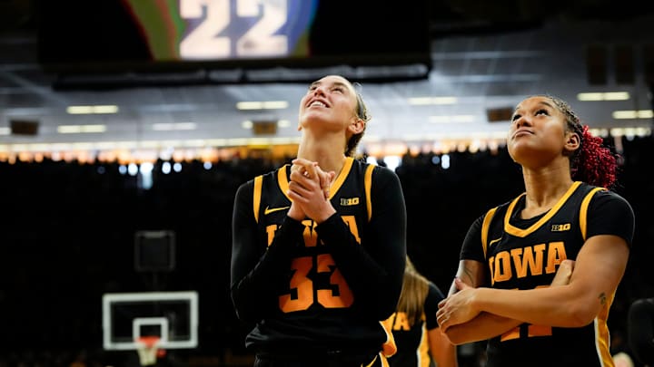 Iowa Hawkeyes guard Lucy Olsen (33) and Iowa Hawkeyes guard Aaliyah Guyton (11) watch Caitlin Clark’s jersey be retired Sunday, Feb. 2, 2025 at Carver-Hawkeye Arena in Iowa City, Iowa. Iowa Hawkeyes guard Lucy Olsen (33) and Iowa Hawkeyes guard Aaliyah Guyton (11) watch Caitlin Clark’s jersey be retired Sunday, Feb. 2, 2025 at Carver-Hawkeye Arena in Iowa City, Iowa.