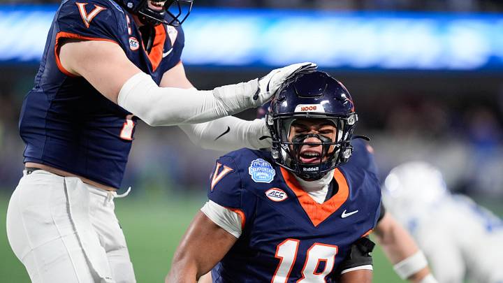 Dec 6, 2025; Charlotte, NC, USA; Virginia Cavaliers safety Corey Costner (18) celebrates an interception in the first quarter against the Duke Blue Devils during the 2025 ACC Championship game at Bank of America Stadium. Mandatory Credit: Jim Dedmon-Imagn Images Dec 6, 2025; Charlotte, NC, USA; Virginia Cavaliers safety Corey Costner (18) celebrates an interception in the first quarter against the Duke Blue Devils during the 2025 ACC Championship game at Bank of America Stadium. Mandatory Credit: Jim Dedmon-Imagn Images