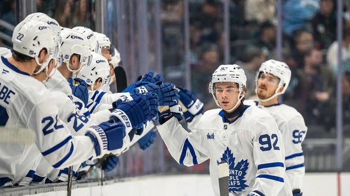Oct 28, 2026; Seattle, Washington, USA; Toronto Maple Leafs forward Gavin McKenna (92) is congratulated by teammates on the bench after scoring a goal during the second period against the Seattle Kraken  at Climate Pledge Arena. Mandatory Credit: Stephen Brashear-Imagn Images