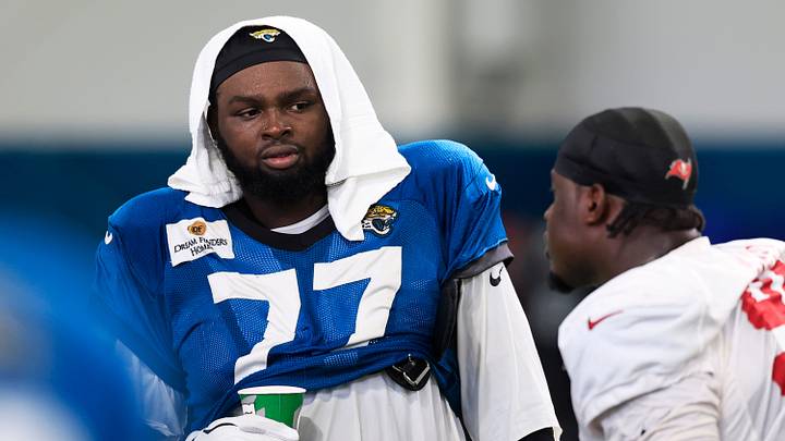 Jacksonville Jaguars offensive tackle Anton Harrison (77) talks with Tampa Bay Buccaneers defensive lineman Calijah Kancey (94) after a joint Buccaneers‑Jaguars NFL practice at the Miller Electric Center on Tuesday, Aug. 25, 2026, in Jacksonville, Fla.