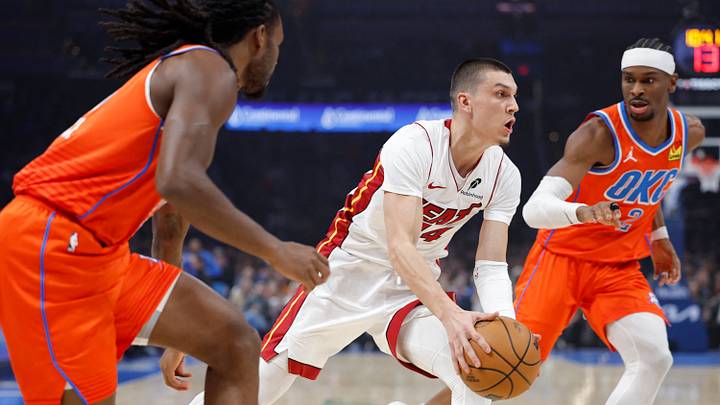 Jan 11, 2026; Oklahoma City, Oklahoma, USA; Miami Heat guard Tyler Herro (14) drives between Oklahoma City Thunder guard Cason Wallace (22) and guard Shai Gilgeous-Alexander (2) during the first quarter at Paycom Center. Mandatory Credit: Alonzo Adams-Imagn Images Jan 11, 2026; Oklahoma City, Oklahoma, USA; Miami Heat guard Tyler Herro (14) drives between Oklahoma City Thunder guard Cason Wallace (22) and guard Shai Gilgeous-Alexander (2) during the first quarter at Paycom Center. Mandatory Credit: Alonzo Adams-Imagn Images