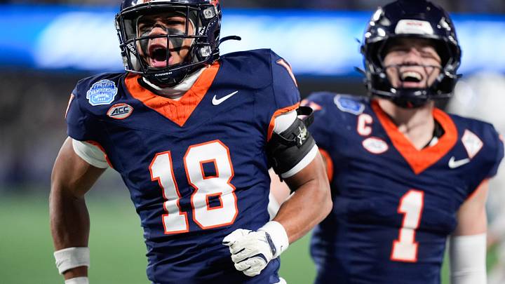 Dec 6, 2025; Charlotte, NC, USA; Virginia Cavaliers safety Corey Costner (18) celebrates an interception in the first quarter against the Duke Blue Devils during the 2025 ACC Championship game at Bank of America Stadium. Mandatory Credit: Jim Dedmon-Imagn Images Dec 6, 2025; Charlotte, NC, USA; Virginia Cavaliers safety Corey Costner (18) celebrates an interception in the first quarter against the Duke Blue Devils during the 2025 ACC Championship game at Bank of America Stadium. Mandatory Credit: Jim Dedmon-Imagn Images