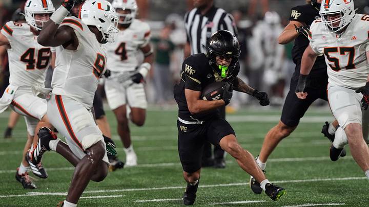 Sep 18, 2026; Winston-Salem, North Carolina, USA; Wake Forest Demon Deacons wide receiver Carlos Hernandez (8) dodges around Miami (FL) Hurricanes during the second half at Allegacy Federal Credit Union Stadium. Mandatory Credit: Jim Dedmon-Imagn Images Sep 18, 2026; Winston-Salem, North Carolina, USA; Wake Forest Demon Deacons wide receiver Carlos Hernandez (8) dodges around Miami (FL) Hurricanes during the second half at Allegacy Federal Credit Union Stadium. Mandatory Credit: Jim Dedmon-Imagn Images