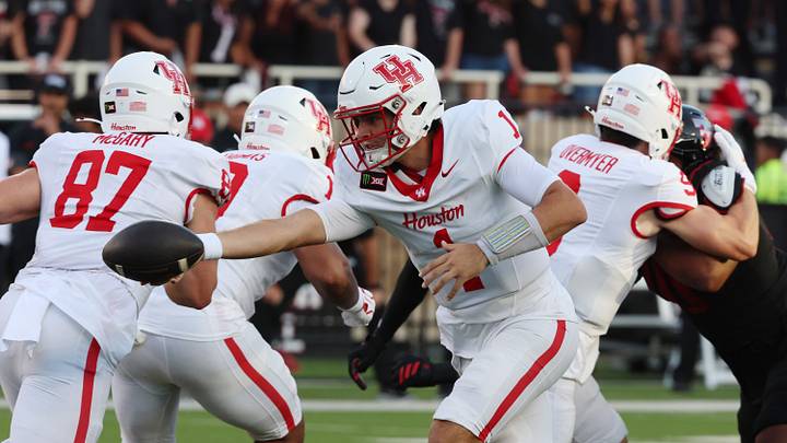 Sep 18, 2026; Lubbock, Texas, USA; Houston Cougars quarterback Conner Weigman (1) hands the ball to running back Makhi Hughes (21) in the first half against the Texas Tech Red Raiders at Galaxy Stadium. Mandatory Credit: Michael C. Johnson-Imagn Images Sep 18, 2026; Lubbock, Texas, USA; Houston Cougars quarterback Conner Weigman (1) hands the ball to running back Makhi Hughes (21) in the first half against the Texas Tech Red Raiders at Galaxy Stadium. Mandatory Credit: Michael C. Johnson-Imagn Images