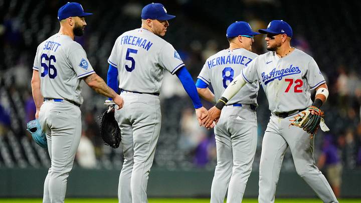 Aug 19, 2026; Denver, Colorado, USA; Los Angeles Dodgers second baseman Miguel Rojas (72), second baseman Enrique Hernandez (8), first baseman Freddie Freeman (5) and relief pitcher Tanner Scott (66) celebrate the tenth inning win against the Colorado Rockies at Coors Field. Mandatory Credit: Ron Chenoy-Imagn Images Aug 19, 2026; Denver, Colorado, USA; Los Angeles Dodgers second baseman Miguel Rojas (72), second baseman Enrique Hernandez (8), first baseman Freddie Freeman (5) and relief pitcher Tanner Scott (66) celebrate the tenth inning win against the Colorado Rockies at Coors Field. Mandatory Credit: Ron Chenoy-Imagn Images