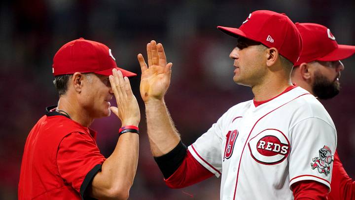 Former Cincinnati Reds first baseman Joey Votto (19) high fives Cincinnati Reds manager David Bell (25) at the conclusion of a baseball game against the Miami Marlins, Thursday, Aug. 19, 2021, at Great American Ball Park in Cincinnati. The Cincinnati Reds won, 6-1. Former Cincinnati Reds first baseman Joey Votto (19) high fives Cincinnati Reds manager David Bell (25) at the conclusion of a baseball game against the Miami Marlins, Thursday, Aug. 19, 2021, at Great American Ball Park in Cincinnati. The Cincinnati Reds won, 6-1.