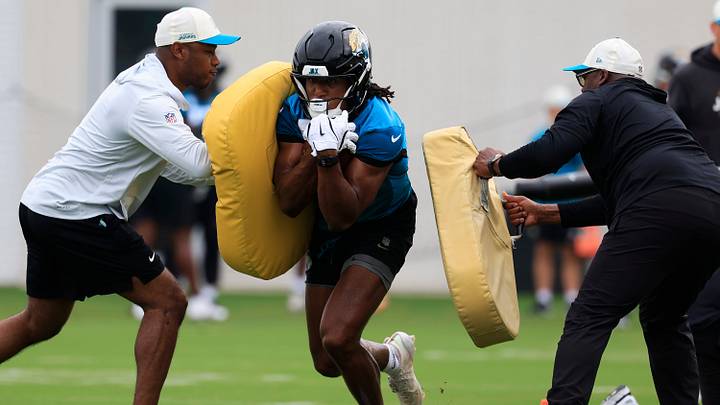 Jacksonville Jaguars wide receiver Josh Cameron (19) runs the ball between Fred Walker offensive assistant and wide receivers coach Edgar Bennett during the first day of NFL Training Camp at the Miller Electric Center on Wednesday, July 29, 2026, in Jacksonville, Fla. Jacksonville Jaguars wide receiver Josh Cameron (19) runs the ball between Fred Walker offensive assistant and wide receivers coach Edgar Bennett during the first day of NFL Training Camp at the Miller Electric Center on Wednesday, July 29, 2026, in Jacksonville, Fla.
