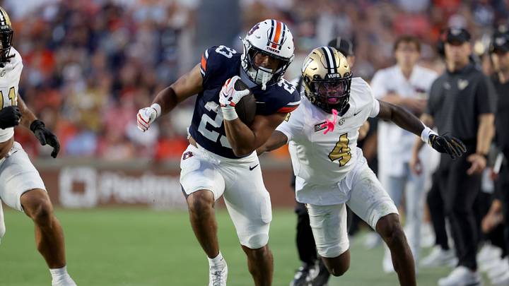 Sep 26, 2026; Auburn, Alabama, USA;  Auburn Tigers running back Jeremiah Cobb (23) runs for a first down as Vanderbilt Commodores cornerback Martel Hight (4) goes for the tackle during the fourth quarter Jordan-Hare Stadium.  Mandatory Credit: John Reed-Imagn Images