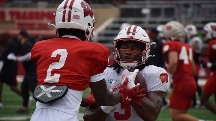 Wisconsin CB Javan Robinson (2) and RB Abu Sama (3). 