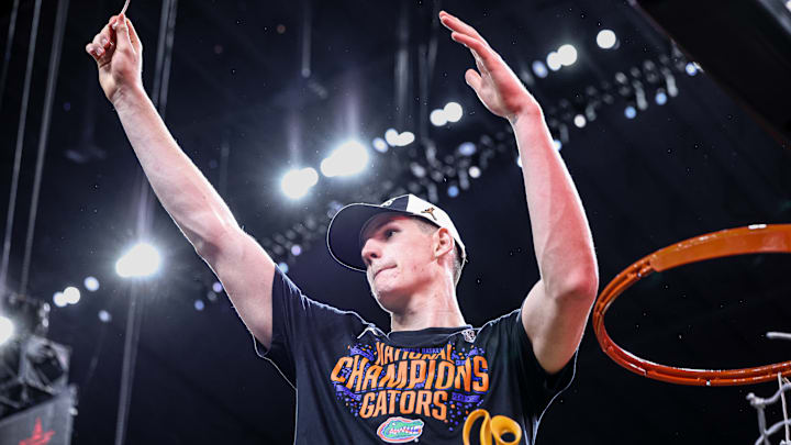Alex Condon helps cut down the net after the Florida Gators' win over Houston in the national championship. Alex Condon helps cut down the net after the Florida Gators' win over Houston in the national championship.