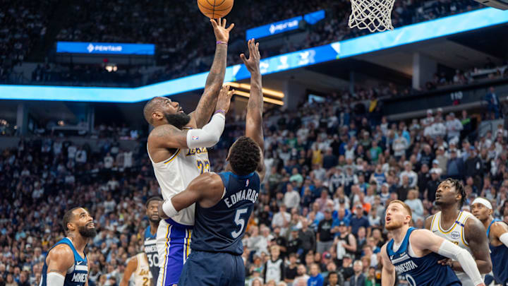 Los Angeles Lakers forward LeBron James shoots over Minnesota Timberwolves guard Anthony Edwards in the second quarter during Game 4 of their first-round playoff series at Target Center in Minneapolis on April 27, 2025. 