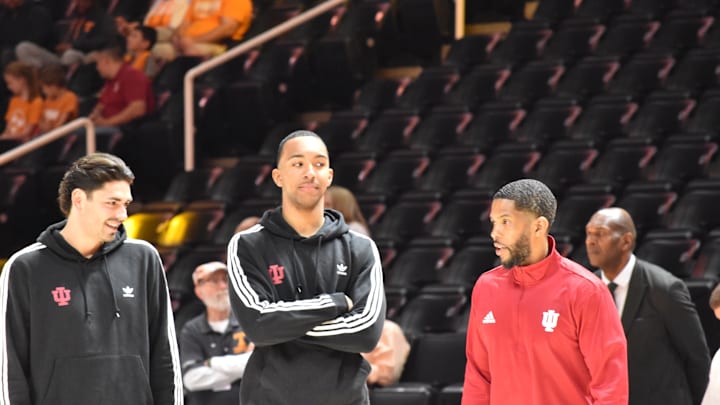 Indiana basketball players Trey Galloway (left) and Bryson Tucker chat with assistant coach Yasir Rosemond before Sunday's exhibition game at the University of Tennessee. 