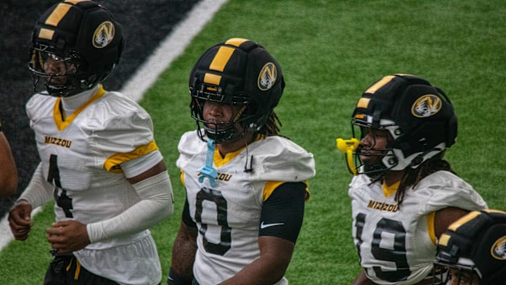 Aug 18, 2025; Columbia, MO, USA; Missouri Tigers safety Caleb Flagg (4), cornerback Stephen Hall (0) and defensive end Darris Smith (19) in fall camp.