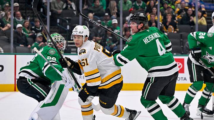 Oct 20, 2026; Dallas, Texas, USA; Dallas Stars goaltender Jake Oettinger (29) and defenseman Miro Heiskanen (4) and Boston Bruins center Matthew Poitras (51) look for the puck during the first period at the American Airlines Center. Mandatory Credit: Jerome Miron-Imagn Images