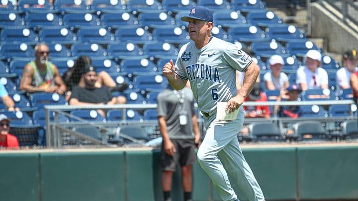 Jun 15, 2025; Omaha, Neb, USA;  Arizona Wildcats head coach Chip Hale (6) runs to the dugout before the game against the Louisville Cardinals at Charles Schwab Field. Mandatory Credit: Steven Branscombe-Imagn Images