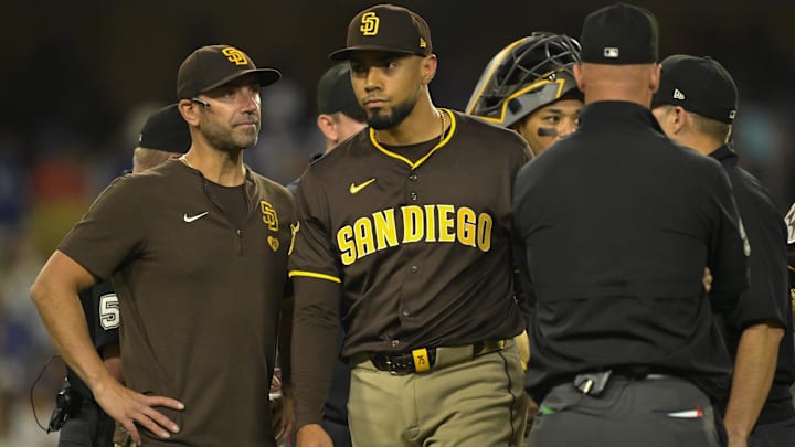 Jun 19, 2025; Los Angeles, California, USA;  San Diego Padres bench coach Brian Esposito (82) looks on as elief pitcher Robert Suarez (75) is ejected from the game after hitting Los Angeles Dodgers designated hitter Shohei Ohtani (17) with a pitch in the ninth inning at Dodger Stadium. Mandatory Credit: Jayne Kamin-Oncea-Imagn Images