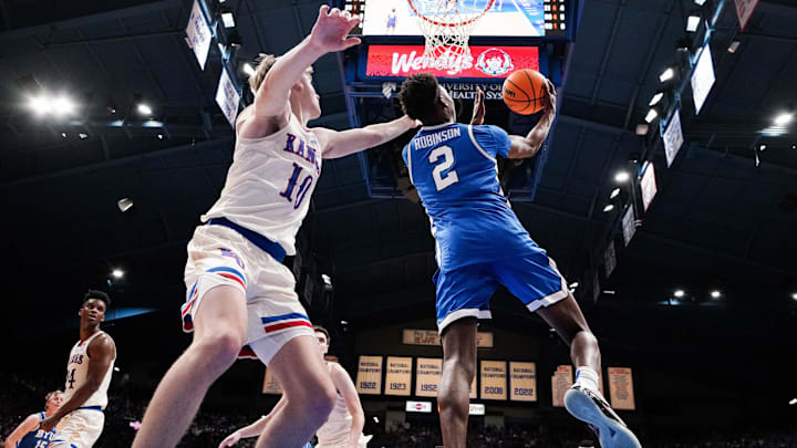 Feb 27, 2024; Lawrence, Kansas, USA; Brigham Young Cougars guard Jaxson Robinson (2) shoots as