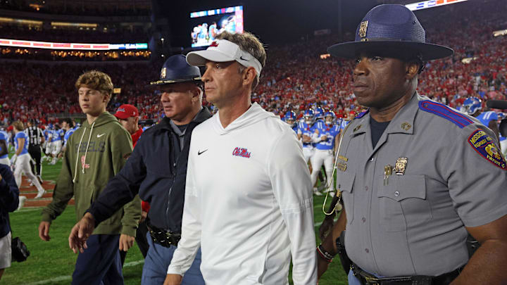 Nov 15, 2025; Oxford, Mississippi, USA; Mississippi Rebels head coach Lane Kiffin  walks onto the field after defeating the Florida Gators at Vaught-Hemingway Stadium. Mandatory Credit: Petre Thomas-Imagn Images