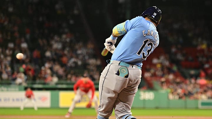 Tampa Bay Rays third baseman Junior Caminero (13) gets a base hit against the Boston Red Sox during first inning at Fenway Park in 2024.