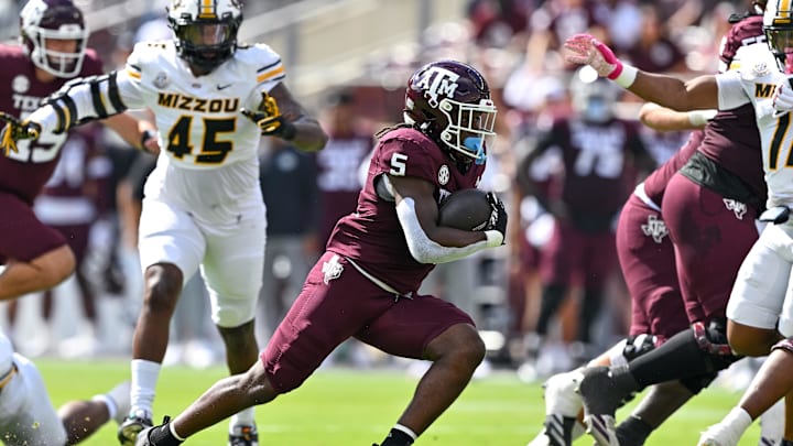 Oct 5, 2024; College Station, Texas, USA; Texas A&M Aggies running back Amari Daniels (5) runs the ball in the first quarter against the Missouri Tigers at Kyle Field. 