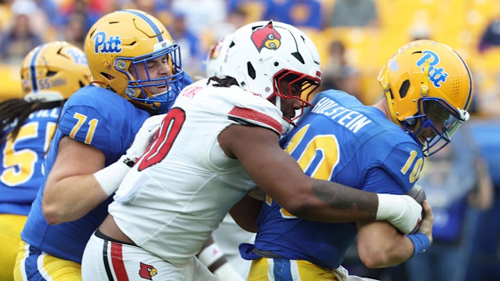Sep 27, 2025; Pittsburgh, Pennsylvania, USA; Louisville Cardinals defensive lineman Rene Konga (90) sacks Pittsburgh Panthers quarterback Eli Holstein (10) during the fourth quarter at Acrisure Stadium. Mandatory Credit: Charles LeClaire-Imagn Images