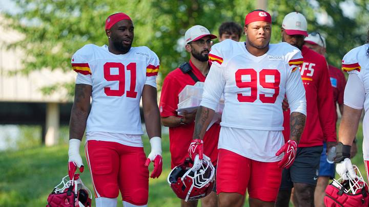 Aug 3, 2026; Kansas City, MO, USA; Kansas City Chiefs   defensive end Felix Anudike-Uzomah (91) and defensive lineman Peter Woods (99) walk down the hill to the fields prior to training camp at Missouri Western University. Mandatory Credit: Denny Medley-Imagn Images