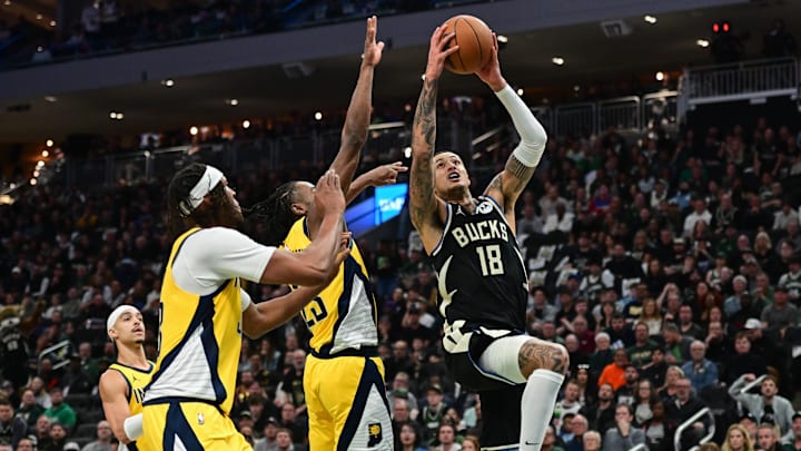 Apr 27, 2025; Milwaukee, Wisconsin, USA; Milwaukee Bucks forward Kyle Kuzma (18) takes a shot against Indiana Pacers forward Aaron Nesmith (23) in the third quarter during game four of first round for the 2024 NBA Playoffs at Fiserv Forum. Mandatory Credit: Benny Sieu-Imagn Images