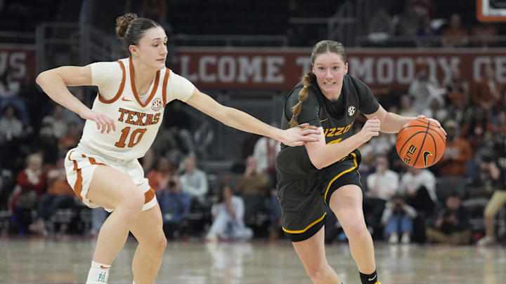 Jan 30, 2025; Austin, Texas, USA; Missouri Tigers guard Grace Slaughter (0) drives to the basket while defended by Texas Longhorns guard Shay Holle (10) during the second half at Moody Center. Mandatory Credit: Scott Wachter-Imagn Images