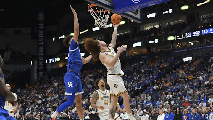 Mar 12, 2026; Nashville, TN, USA;  Missouri Tigers guard T.O. Barrett (5) lays the ball in over Kentucky Wildcats center Malachi Moreno (24) during the first half at Bridgestone Arena. Mandatory Credit: Steve Roberts-Imagn Images