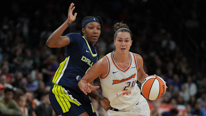 Jul 7, 2025; Phoenix, Arizona, USA; Phoenix Mercury forward Kathryn Westbeld (24) drives on Dallas Wings guard Liata King in the second half at Footprint Center. Mandatory Credit: Rick Scuteri-Imagn Images