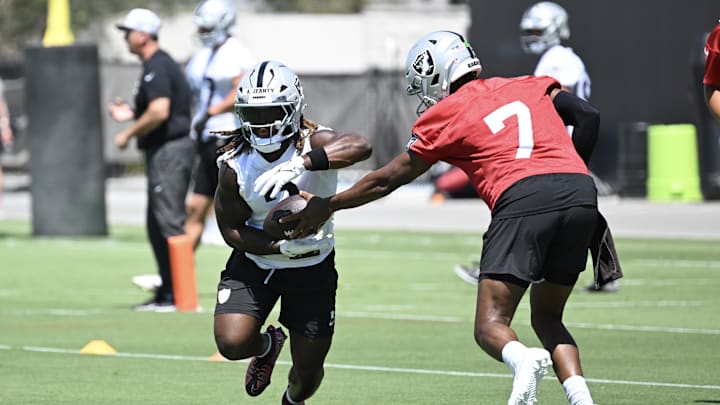 Jun 10, 2025; Henderson, NV, USA; Las Vegas Raiders quarterback Geno Smith (7) hands the ball off to running back Ashton Jeanty (2) during Las Vegas Raiders Minicamp at Intermountain Health Performance Center. Mandatory Credit: Candice Ward-Imagn Images