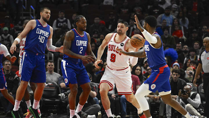 Mar 14, 2024; Chicago, Illinois, USA;  Chicago Bulls center Nikola Vucevic (9) passes the ball away from LA Clippers forward Kawhi Leonard (2), LA Clippers center Ivica Zubac (40) and LA Clippers forward Paul George (13) during the first half at the United Center. Mandatory Credit: Matt Marton-Imagn Images
