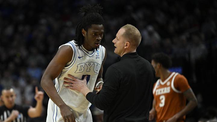 Mar 19, 2026; Portland, OR, USA; BYU Cougars head coach Kevin Young talks to forward Khadim Mboup (7) in the first half against the Texas Longhorns during a first round game of the men's 2026 NCAA Tournament at Moda Center. Mandatory Credit: Troy Wayrynen-Imagn Images Mar 19, 2026; Portland, OR, USA; BYU Cougars head coach Kevin Young talks to forward Khadim Mboup (7) in the first half against the Texas Longhorns during a first round game of the men's 2026 NCAA Tournament at Moda Center. Mandatory Credit: Troy Wayrynen-Imagn Images