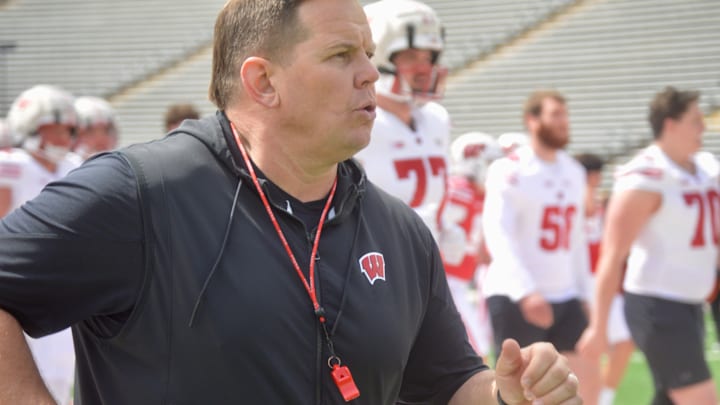 Wisconsin assistant AJ Blazek jogs off to offensive line drills during the Badgers football spring showcase April 19.