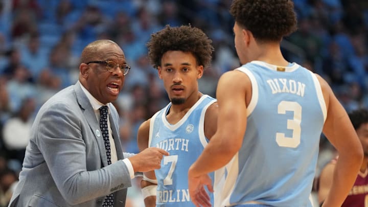 Dec 30, 2025; Chapel Hill, North Carolina, USA; North Carolina Tar Heels head coach Hubert Davis with guard Seth Trimble (7) and guard Derek Dixon (3) in the second half at Dean E. Smith Center. Mandatory Credit: Bob Donnan-Imagn Images