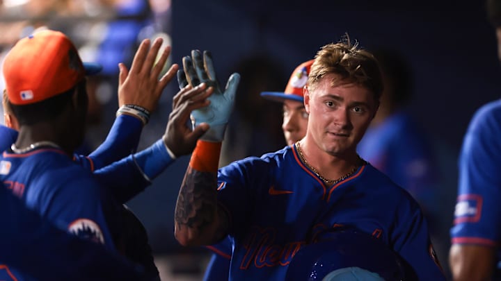 Mar 13, 2026; West Palm Beach, Florida, USA; New York Mets left fielder A.J. Ewing (97) celebrates with teammates after scoring against the Washington Nationals during the fifth inning at CACTI Park of the Palm Beaches. Mandatory Credit: Sam Navarro-Imagn Images