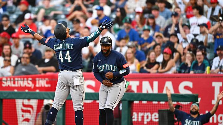 Apr 4, 2026; Anaheim, California, USA; Seattle Mariners center fielder Julio Rodríguez (44) celebrates with first base coach Eric Young Jr. (53) after hitting a single against the Los Angeles Angels during the first inning at Angel Stadium. Mandatory Credit: Jonathan Hui-Imagn Images Apr 4, 2026; Anaheim, California, USA; Seattle Mariners center fielder Julio Rodríguez (44) celebrates with first base coach Eric Young Jr. (53) after hitting a single against the Los Angeles Angels during the first inning at Angel Stadium. Mandatory Credit: Jonathan Hui-Imagn Images